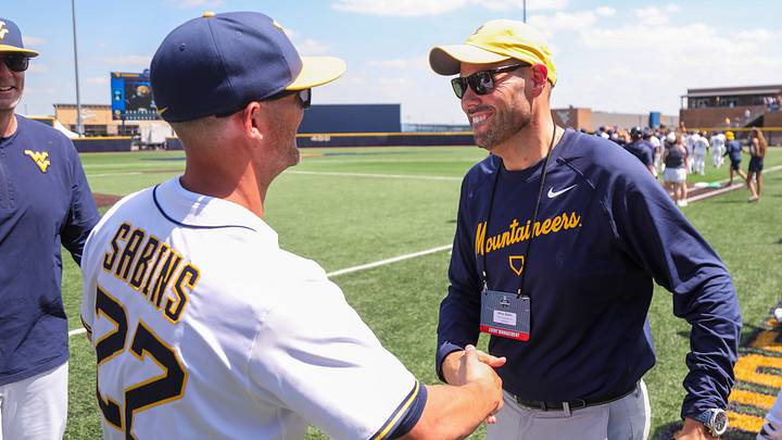 Jun 5, 2026; Morgantown, WV, USA; West Virginia Mountaineers athletic director Wren Baker celebrates with West Virginia Mountaineers head coach Steve Sabins after defeating the Cal Poly Mustangs at Kendrick Family Ballpark. Mandatory Credit: Ben Queen-Imagn Images