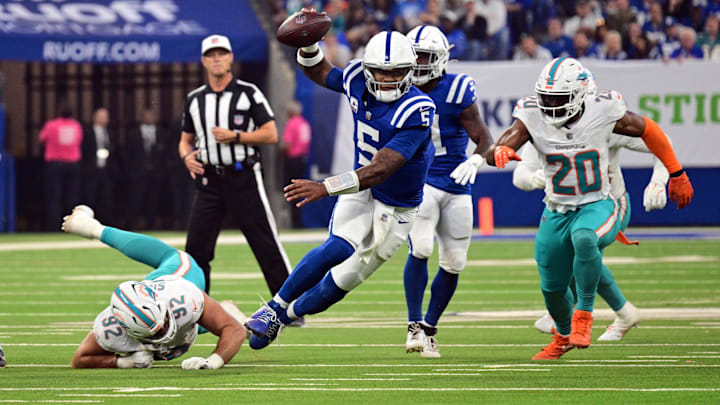 Oct 20, 2024; Indianapolis, Indiana, USA; Indianapolis Colts quarterback Anthony Richardson (5) evades tackle by Miami Dolphins defensive tackle Zach Sieler (92) during the first quarter at Lucas Oil Stadium. Mandatory Credit: Marc Lebryk-Imagn Images