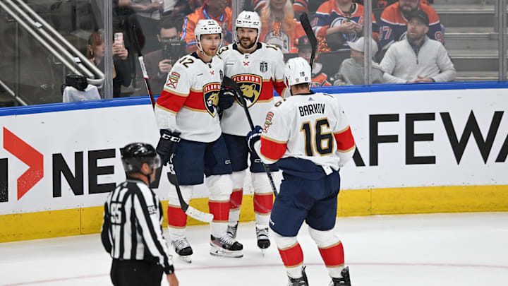 Florida Panthers center Sam Reinhart celebrates a goal with defenseman Gustav Forsling and center Aleksander Barkov.