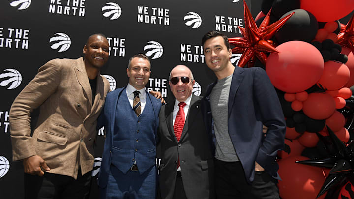 Jun 13, 2023; Toronto, Ontario, Canada; Toronto Raptors new head coach Darko Rajakovic (second left) poses for a photo with (from left) team president Masai Ujiri, team co-owner Larry Tanenbaum and general manager Bobby Webster during an introductory media conference at Scotiabank Arena. Mandatory Credit: Dan Hamilton-Imagn Images Jun 13, 2023; Toronto, Ontario, Canada; Toronto Raptors new head coach Darko Rajakovic (second left) poses for a photo with (from left) team president Masai Ujiri, team co-owner Larry Tanenbaum and general manager Bobby Webster during an introductory media conference at Scotiabank Arena. Mandatory Credit: Dan Hamilton-Imagn Images