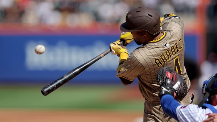 Sep 18, 2025; New York City, New York, USA; San Diego Padres second baseman Luis Arraez (4) hits an RBI sacrifice fly against the New York Mets during the third inning at Citi Field. Mandatory Credit: Brad Penner-Imagn Images