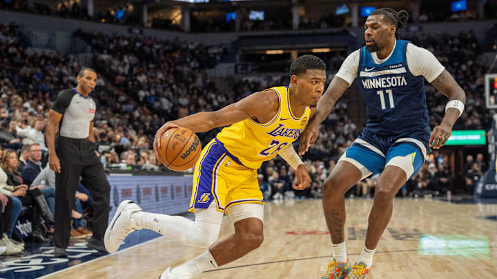 Dec 13, 2024; Minneapolis, Minnesota, USA; Los Angeles Lakers forward Rui Hachimura (28) drives on Minnesota Timberwolves center Naz Reid (11) in the second quarter at Target Center.
