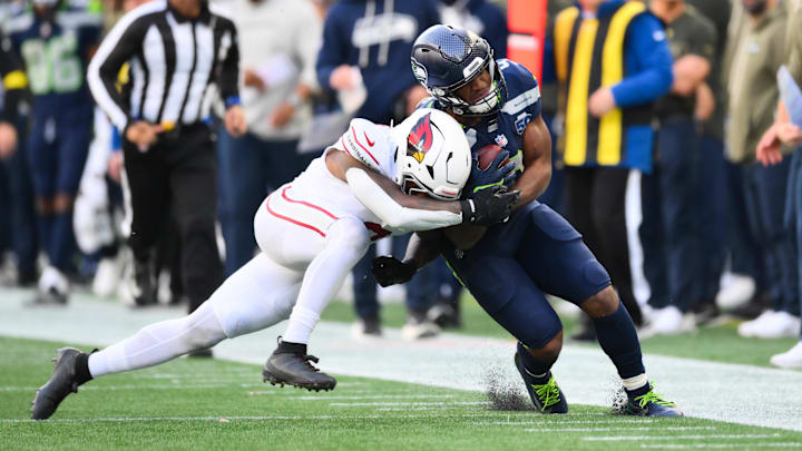 Nov 9, 2025; Seattle, Washington, USA; Seattle Seahawks running back Kenneth Walker III (9) is tackled out of bounds by Arizona Cardinals safety Budda Baker (3) during the second quarter at Lumen Field. Mandatory Credit: Steven Bisig-Imagn Images