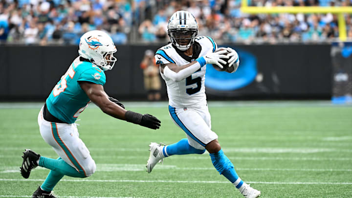 Oct 5, 2025; Charlotte, North Carolina, USA; Carolina Panthers running back Rico Dowdle (5) with the ball as Miami Dolphins linebacker Tyrel Dodson (25) defends in the second quarter at Bank of America Stadium. Mandatory Credit: Bob Donnan-Imagn Images