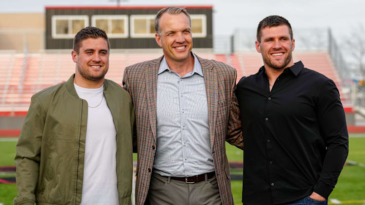 Brothers Derek, left, and TJ Watt, right, pose for a photo with Chris McIntosh, Athletic Director at the University of Wisconsin-Madison, during a jersey retirement ceremony for the Watt brothers at Pewaukee High School, Friday, May 5, 2023. McIntosh graduated from Pewaukee in 1995 and had his jersey retired in 2000. Brothers Derek, left, and TJ Watt, right, pose for a photo with Chris McIntosh, Athletic Director at the University of Wisconsin-Madison, during a jersey retirement ceremony for the Watt brothers at Pewaukee High School, Friday, May 5, 2023. McIntosh graduated from Pewaukee in 1995 and had his jersey retired in 2000.