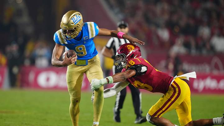 Nov 29, 2025; Los Angeles, California, USA; UCLA Bruins quarterback Nico Iamaleava (9) is tackled by Southern California Trojans linebacker Eric Gentry (18) in the second half at United Airlines Field at Los Angeles Memorial Coliseum. Mandatory Credit: Kirby Lee-Imagn Images Nov 29, 2025; Los Angeles, California, USA; UCLA Bruins quarterback Nico Iamaleava (9) is tackled by Southern California Trojans linebacker Eric Gentry (18) in the second half at United Airlines Field at Los Angeles Memorial Coliseum. Mandatory Credit: Kirby Lee-Imagn Images