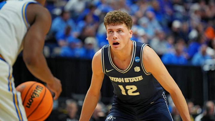Mar 20, 2025; Lexington, KY, USA; Utah State Aggies guard Mason Falslev (12) guards UCLA Bruins guard Dylan Andrews (2) in the first round of the NCAA Tournament at Rupp Arena. Mar 20, 2025; Lexington, KY, USA; Utah State Aggies guard Mason Falslev (12) guards UCLA Bruins guard Dylan Andrews (2) in the first round of the NCAA Tournament at Rupp Arena.