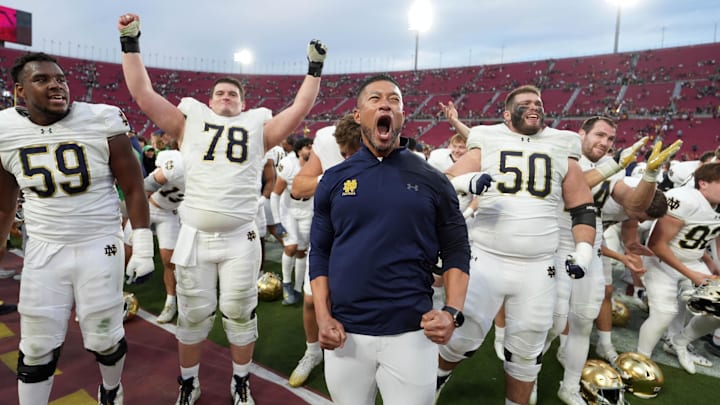 Nov 30, 2024; Los Angeles, California, USA; Notre Dame Fighting Irish head coach Marcus Freeman celebrates with players at the end of the game against the Southern California Trojans at United Airlines Field at Los Angeles Memorial Coliseum. Mandatory Credit: Kirby Lee-Imagn Images Nov 30, 2024; Los Angeles, California, USA; Notre Dame Fighting Irish head coach Marcus Freeman celebrates with players at the end of the game against the Southern California Trojans at United Airlines Field at Los Angeles Memorial Coliseum. Mandatory Credit: Kirby Lee-Imagn Images