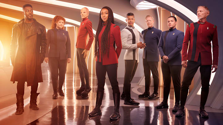 L-R David Ajala as Book, Mary Wiseman as Tilly, Doug Jones as Saru, Sonequa Martin-Green as Burnham, Wilson Cruz as Culber, Blu Del Barrio as Adira and Callum Keith Rennie as Raynor in season 5 of the Paramount+ original series STAR TREK: DISCOVERY. Photo Credit: James Dimmock/Paramount+