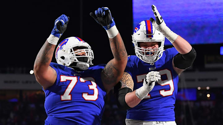 Buffalo Bills offensive tackle Dion Dawkins (73) and offensive tackle Spencer Brown (79) celebrate a touchdown against the New York Jets during the second half at Highmark Stadium. 