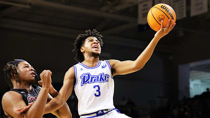 Drake guard Colby Garland (3) flies past Missouri State N.J. Benson (35) for the lay-up as the Missouri State Bears play the Drake Bulldogs at the Knapp Center in Missouri Valley Conference action in Des Moines on Saturday, December 2, 2023.