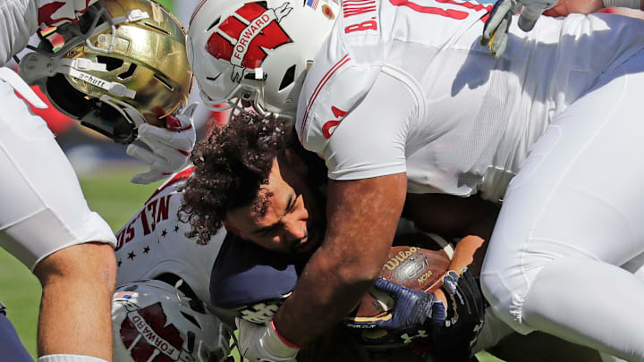 Notre Dame Fighting Irish running back Kyren Williams (23) loses his helmet as he is brought down by Wisconsin Badgers linebacker nose tackle Bryson Williams (91) during their football game Saturday, September 25, 2021, at Soldier Field in Chicago, Ill. Dan Powers/USA TODAY NETWORK-Wisconsin
