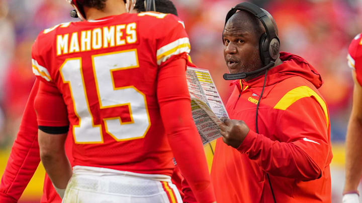 Oct 16, 2022; Kansas City, Missouri, USA; Kansas City Chiefs offensive coordinator Eric Bieniemy talks with quarterback Patrick Mahomes (15) during the second half against the Buffalo Bills at GEHA Field at Arrowhead Stadium.