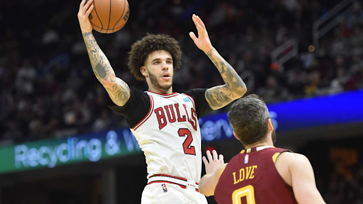 Dec 8, 2021; Cleveland, Ohio, USA; Chicago Bulls guard Lonzo Ball (2) drives to the basket beside Cleveland Cavaliers forward Kevin Love (0) in the third quarter at Rocket Mortgage FieldHouse. Mandatory Credit: David Richard-Imagn Images Dec 8, 2021; Cleveland, Ohio, USA; Chicago Bulls guard Lonzo Ball (2) drives to the basket beside Cleveland Cavaliers forward Kevin Love (0) in the third quarter at Rocket Mortgage FieldHouse. Mandatory Credit: David Richard-Imagn Images