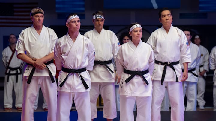 Cobra Kai. (L to R) William Zabka as Johnny Lawrence, Tanner Buchanan as Robby Keene, Ralph Macchio as Daniel LaRusso, Mary Mouser as Samantha LaRusso, Yuji Okumoto as Chozen in Cobra Kai. Cr. Curtis Bonds Baker/Netflix © 2024