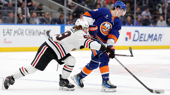 Mar 24, 2026; Elmont, New York, USA; New York Islanders defenseman Matthew Schaefer (48) plays the puck against Chicago Blackhawks left wing Tyler Bertuzzi (59) during the third period at UBS Arena. Mandatory Credit: Brad Penner-Imagn Images