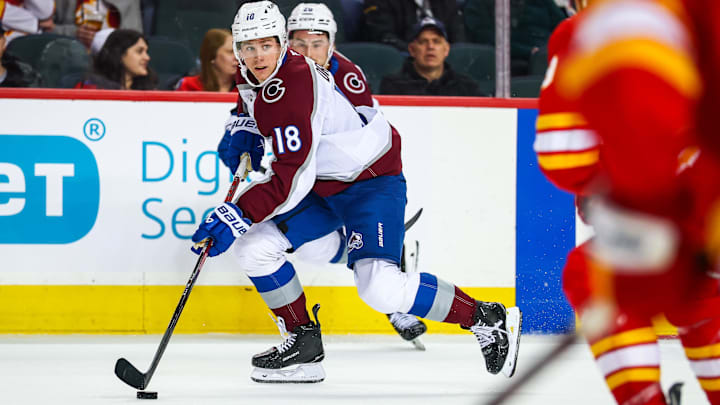 Colorado Avalanche center Jack Drury (18) controls the puck against the Calgary Flames.
