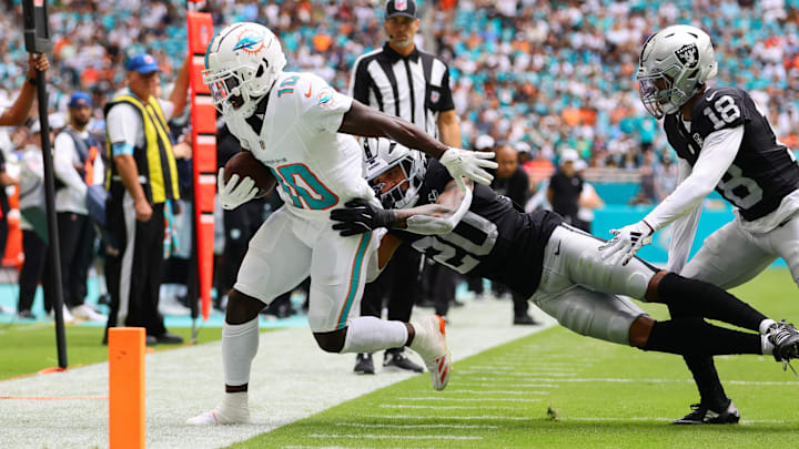 Miami Dolphins wide receiver Tyreek Hill (10) is pushed out of bounds by Las Vegas Raiders safety Isaiah Pola-Mao (20) during the first quarter at Hard Rock Stadium.