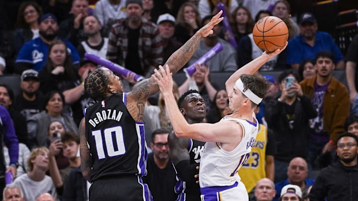 Oct 26, 2025; Sacramento, California, USA; Los Angeles Lakers guard Austin Reaves (15) looks to pass the ball against Sacramento Kings guard/forward DeMar Derozan (10) during the fourth quarter at Golden 1 Center. Mandatory Credit: Ed Szczepanski-Imagn Images