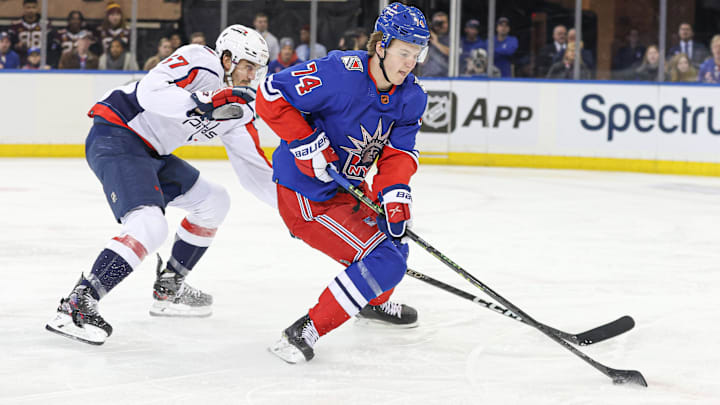 Dec 27, 2022; New York, New York, USA; New York Rangers right wing Vitali Kravtsov (74) skates with the puck against Washington Capitals defenseman Trevor van Riemsdyk (57) during the first period at Madison Square Garden. Mandatory Credit: Vincent Carchietta-Imagn Images