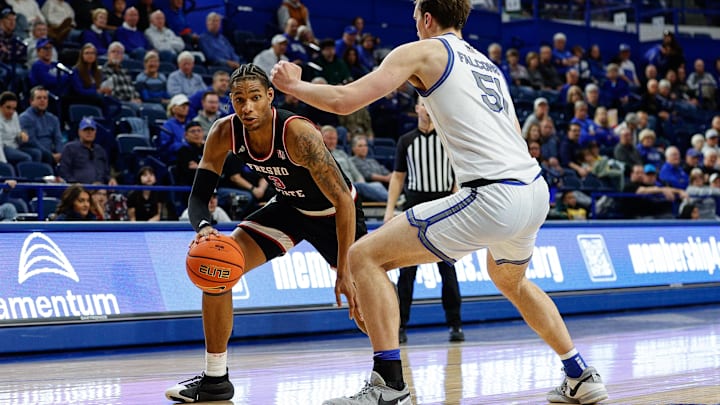 Feb 22, 2025; Colorado Springs, Colorado, USA; Fresno State Bulldogs forward Elijah Price (3) controls the ball as Air Force Falcons center Wesley Celichowski (51) guards in the second half at Clune Arena. Mandatory Credit: Isaiah J. Downing-Imagn Images