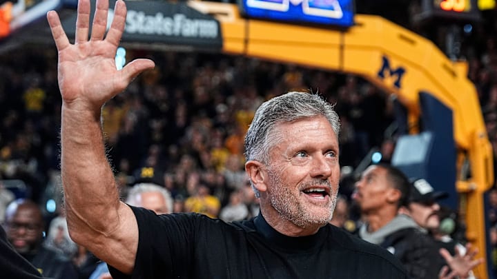 Michigan football head coach Kyle Whittingham waves at the crowd as he is being introduced on the floor during the first half between Michigan and USC at Crisler Center in Ann Arbor on Friday, Jan. 2, 2026.