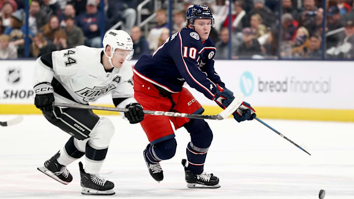 Blue Jackets forward Dmitri Voronkov tries to shield Kings defenseman Mikey Anderson from the puck. 