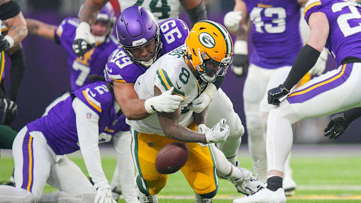 Green Bay Packers running back Josh Jacobs (8) fumbles on the opening drive against the Minnesota Vikings on Sunday.
