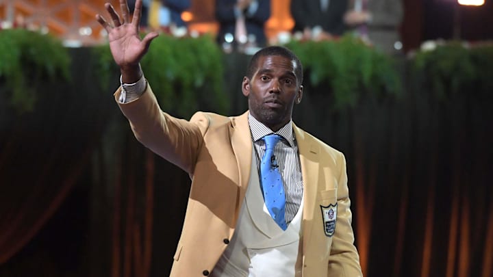 Aug 3, 2018; Canton, OH, USA; Minnesota Vikings, Oakland Raiders, New England Patriots, Tennessee Titans and San Francisco 49ers former receiver Randy Moss reacts after receiving gold jacket  during the Enshrinee's gold jacket dinner at the Canton Civic Center. Mandatory Credit: Kirby Lee-Imagn Images