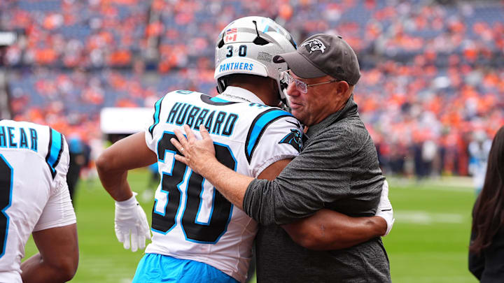 Oct 27, 2024; Denver, Colorado, USA; Carolina Panthers owner David Tepper greets running back Chuba Hubbard (30) before the game against the Denver Broncos at Empower Field at Mile High. Mandatory Credit: Ron Chenoy-Imagn Images