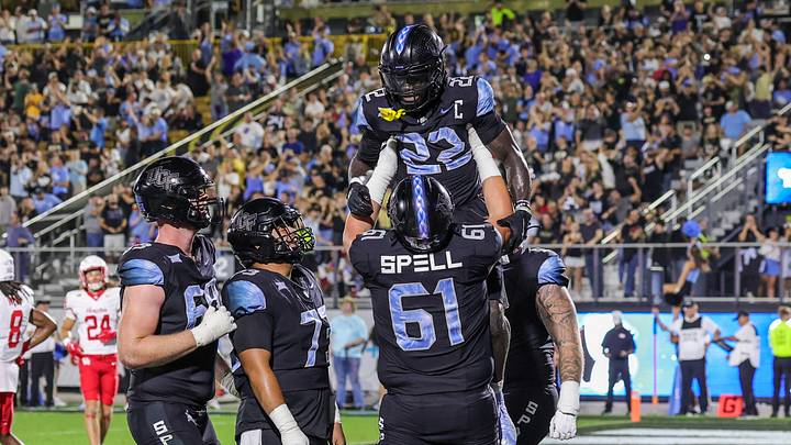 Nov 7, 2025; Orlando, Florida, USA; UCF Knights running back Myles Montgomery (22) is lifted into the air by offensive lineman Owen Spell (61) after scoring during the second quarter at Acrisure Bounce House. Mandatory Credit: Mike Watters-Imagn Images Nov 7, 2025; Orlando, Florida, USA; UCF Knights running back Myles Montgomery (22) is lifted into the air by offensive lineman Owen Spell (61) after scoring during the second quarter at Acrisure Bounce House. Mandatory Credit: Mike Watters-Imagn Images