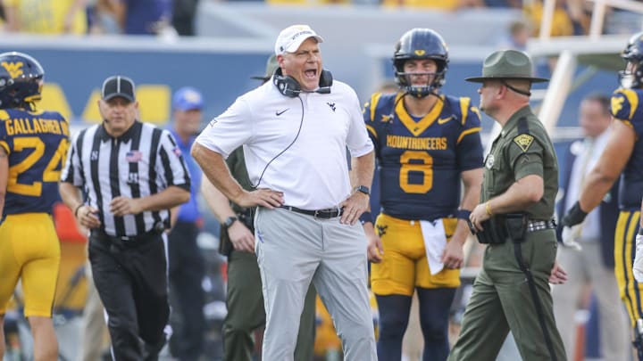 Sep 13, 2025; Morgantown, West Virginia, USA; West Virginia Mountaineers head coach Rich Rodriguez yells at the referee during the second quarter against the Pittsburgh Panthers at Milan Puskar Stadium. Mandatory Credit: Ben Queen-Imagn Images