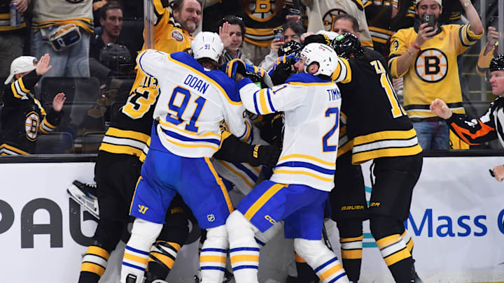 Apr 26, 2026; Boston, Massachusetts, USA; The Boston Bruins and Buffalo Sabres fight along the boards during the third period in game four of the first round of the 2026 Stanley Cup Playoffs at TD Garden. Mandatory Credit: Bob DeChiara-Imagn Images