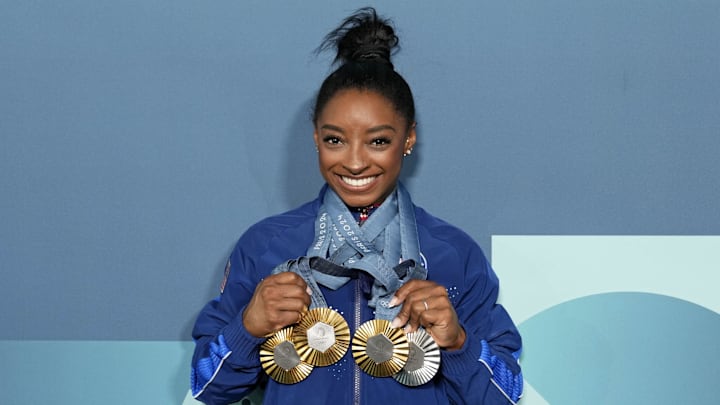 Aug 5, 2024; Paris, France; Simone Biles of the United States poses for a photo with her three gold and one silver medal after day three of the gymnastics event finals during the Paris 2024 Olympic Summer Games. Mandatory Credit: Kyle Terada-Imagn Images Aug 5, 2024; Paris, France; Simone Biles of the United States poses for a photo with her three gold and one silver medal after day three of the gymnastics event finals during the Paris 2024 Olympic Summer Games. Mandatory Credit: Kyle Terada-Imagn Images