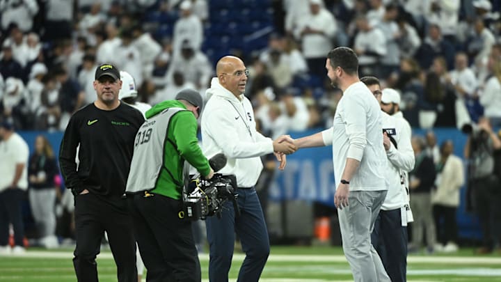 Dec 7, 2024; Indianapolis, IN, USA; Penn State Nittany Lions head coach James Franklin shakes hands with Oregon Ducks head coach Dan Lanning in the 2024 Big Ten Championship game at Lucas Oil Stadium. Mandatory Credit: Robert Goddin-Imagn Images
