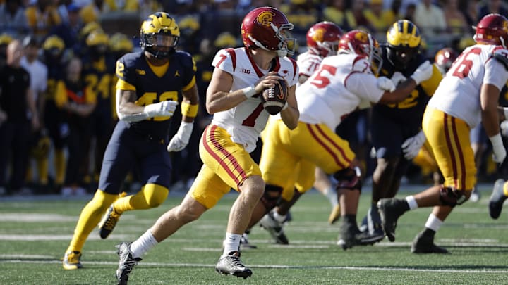 Sep 21, 2024; Ann Arbor, Michigan, USA;  USC Trojans quarterback Miller Moss (7) rolls out to pass against the Michigan Wolverines at Michigan Stadium. Mandatory Credit: Rick Osentoski-Imagn Images
