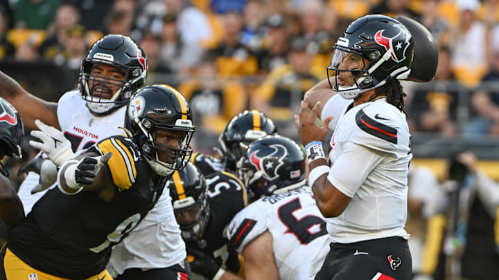 Aug 9, 2024; Pittsburgh, Pennsylvania, USA;  Houston Texans quarterback C.J. Stroud (7) throws a pass while being pressured by Pittsburgh Steelers defensive tackle Keeanu Benton during the first quarter at Acrisure Stadium. Mandatory Credit: Barry Reeger-Imagn Images