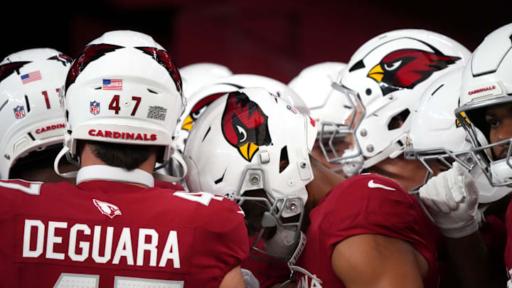 Arizona Cardinals players huddle up before their game against the Las Vegas Raiders at State Farm Stadium in Glendale, on Aug. 23, 2025.