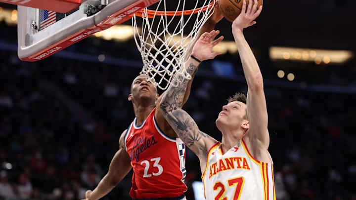 Jan 4, 2025; Inglewood, California, USA;  Los Angeles Clippers forward Kai Jones (23) blocks a dunk attempt by Atlanta Hawks guard Vit Krejci (27) during the second half at Intuit Dome. Mandatory Credit: Kiyoshi Mio-Imagn Images