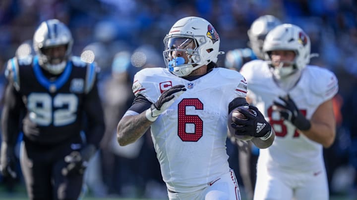 Dec 22, 2024; Charlotte, North Carolina, USA; Arizona Cardinals running back James Conner (6) runs for yardage against the Carolina Panthers during the second quarter at Bank of America Stadium. Mandatory Credit: Jim Dedmon-Imagn Images
