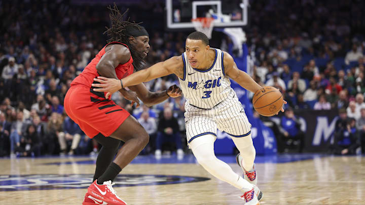 Nov 10, 2025; Orlando, Florida, USA; Orlando Magic guard Desmond Bane (3) drives the ball past Portland Trail Blazers guard Jrue Holiday (5) in the fourth quarter at Kia Center. Mandatory Credit: Nathan Ray Seebeck-Imagn Images