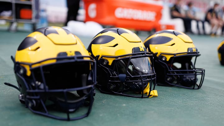Dec 31, 2024; Tampa, FL, USA; Michigan Wolverines helmets sit on the field before a game against the Alabama Crimson Tide at Raymond James Stadium. Mandatory Credit: Matt Pendleton-Imagn Images