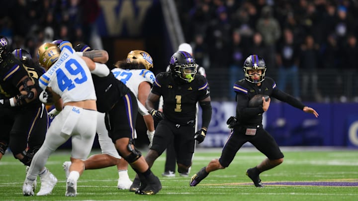 Nov 15, 2024; Seattle, Washington, USA; Washington Huskies quarterback Demond Williams Jr. (2) carries the ball against the UCLA Bruins during the second half at Alaska Airlines Field at Husky Stadium. Mandatory Credit: Steven Bisig-Imagn Images