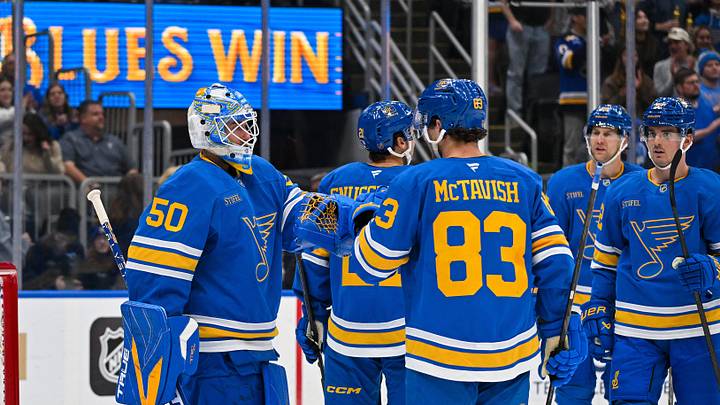 Oct 10, 2026; St. Louis, Missouri, USA; St. Louis Blues goaltender Jordan Binnington (50) celebrates with center Mason McTavish (83) after the Blues defeated the Columbus Blue Jackets at Enterprise Center. Mandatory Credit: Jeff Curry-Imagn Images