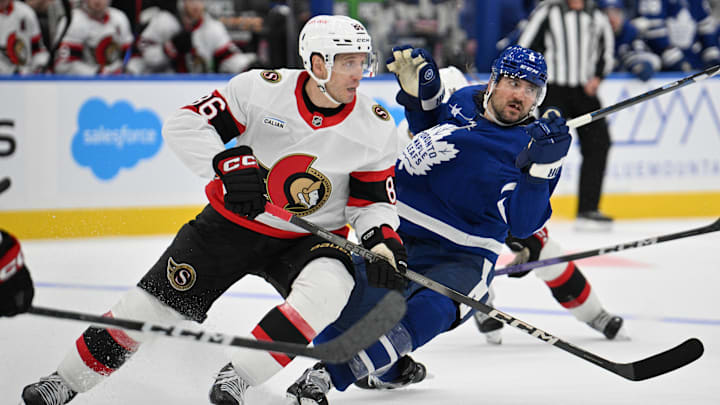 Sep 22, 2024; Toronto, Ontario, CAN;  Ottawa Senators forward Nikolay Kulemin (86) knocks over Toronto Maple Leafs defenseman Chris Tanev (8) in the second period at Scotiabank Arena. Mandatory Credit: Dan Hamilton-Imagn Images