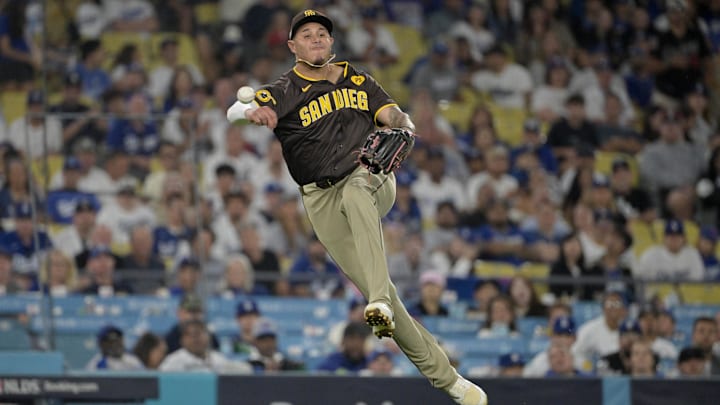 San Diego Padres third baseman Manny Machado throws to first during Game 2 of an NLDS against the Los Angeles Dodgers on Sunday at Dodger Stadium.
