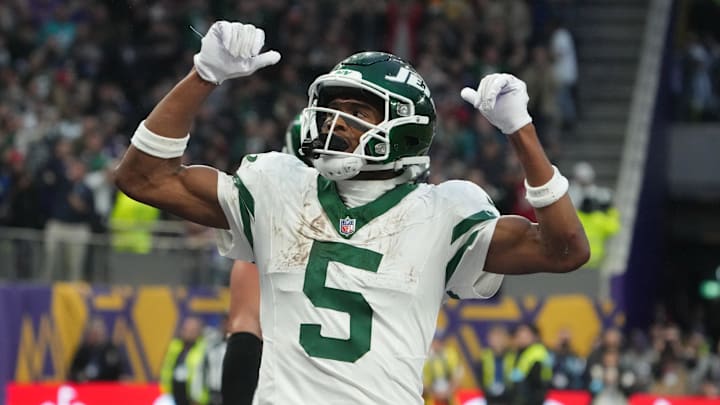 Oct 6, 2024; London, United Kingdom; New York Jets wide receiver Garrett Wilson (5) celebrates after scoring on a 1-yard touchdown reception against the New York Jets in the fourth quarter at Tottenham Hotspur Stadium. Mandatory Credit: Kirby Lee-Imagn Images