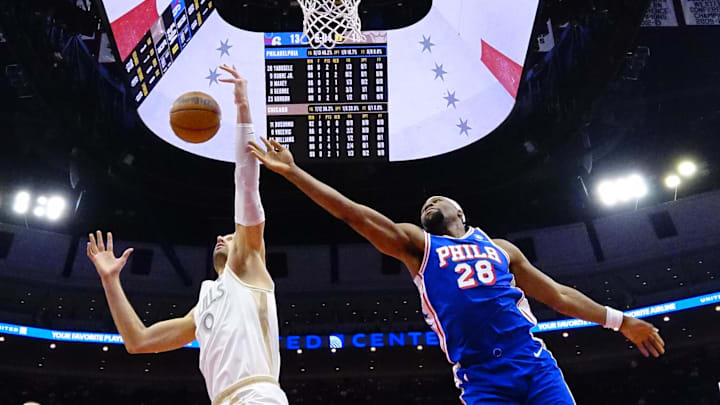 Jan 25, 2025; Chicago, Illinois, USA; Philadelphia 76ers forward Guerschon Yabusele (28) and Chicago Bulls center Nikola Vucevic (9) go for the ball during the first half at United Center. Mandatory Credit: David Banks-Imagn Images