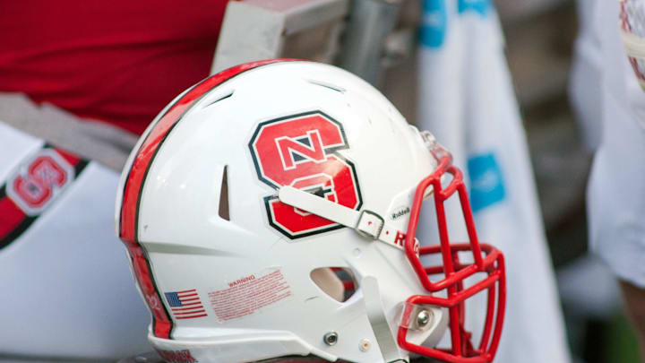 Sep 5, 2015; Raleigh, NC, USA; A North Carolina State Wolfpack helmet lays on the field during the first half against the Troy Trojans at Carter Finley Stadium. North Carolina State defeated Troy 49-21. Mandatory Credit: Jeremy Brevard-Imagn Images