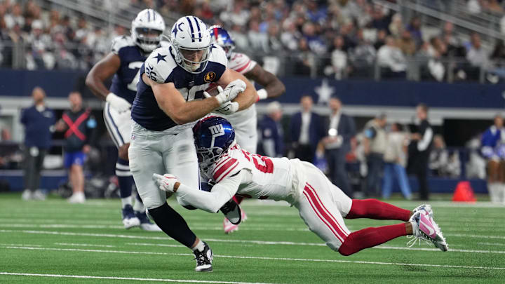 Dallas Cowboys tight end Luke Schoonmakercatches a pass as New York Giants cornerback Cor'Dale Flot defends.